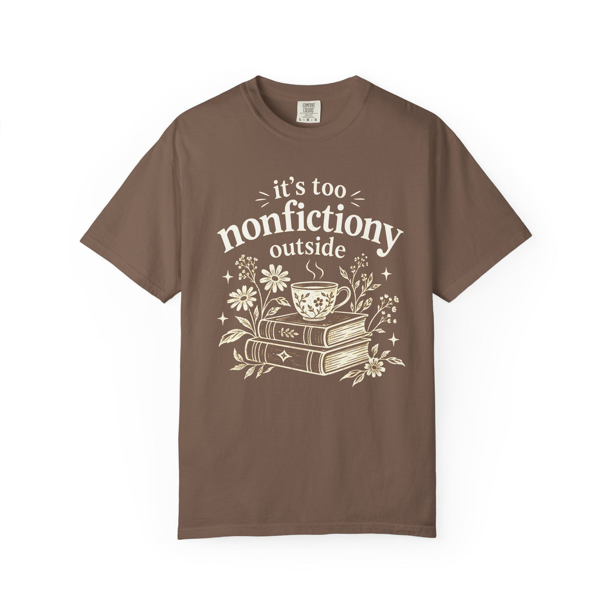 Comfort Colors shirt with cream “it’s too nonfictiony outside” text, stacked books, steaming teacup and daisies