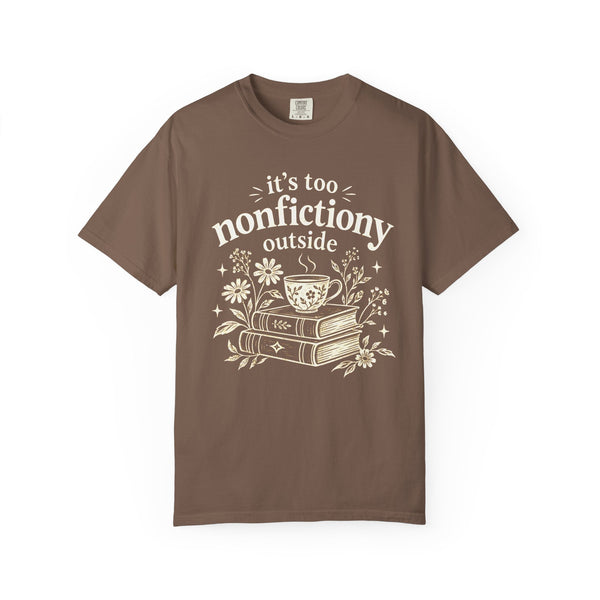 Comfort Colors shirt with cream “it’s too nonfictiony outside” text, stacked books, steaming teacup and daisies